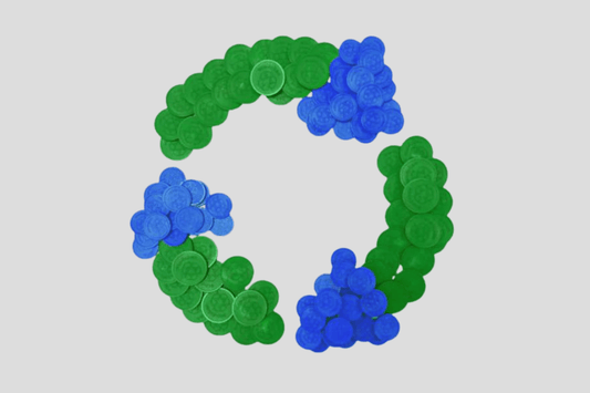 En grön och blå Biologiskt nedbrytbara plasttokens i lagercirkel.